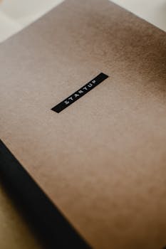 Minimal close-up of a brown paper with 'Startup' highlighted, symbolizing new business ideas.