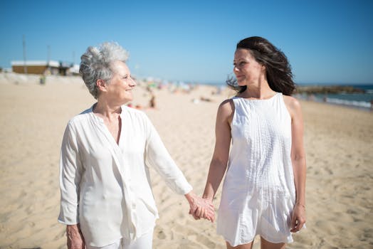 Joyful moment of a mother and daughter holding hands on a sunny beach in Portugal.
