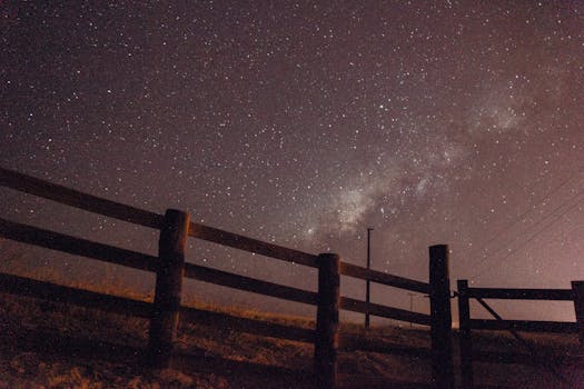 Scenic view of a star-filled sky with Milky Way visible over a fence in Paragominas, Brazil.