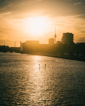 Stunning sunrise view of Berlin skyline with the Spree River reflecting the golden light, featuring iconic TV Tower.